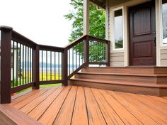 a wooden porch with steps leading up to the front door