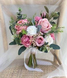 a bouquet of pink and white flowers on a chair