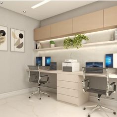 an office with two desks and three monitors