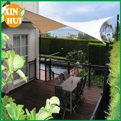 an outdoor deck with table, chairs and umbrella