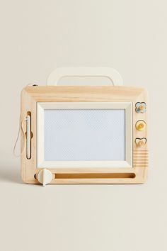 an old fashioned wooden microwave oven sitting on top of a table