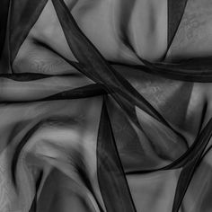 black and white photograph of sheer fabric with wavy lines in the center, as if it were clothing