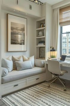 a living room filled with furniture and a white table topped with a laptop next to a window