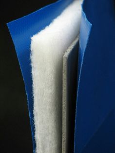 an open blue and white piece of material on a black surface with the end section partially covered in felt