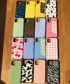 the phone cases are all lined up on the wooden floor and ready to be used