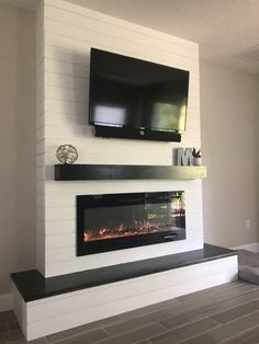 a fireplace with a flat screen tv above it