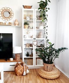 a living room filled with furniture and a flat screen tv sitting on top of a wooden floor