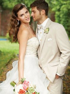 a bride and groom pose for a wedding photo