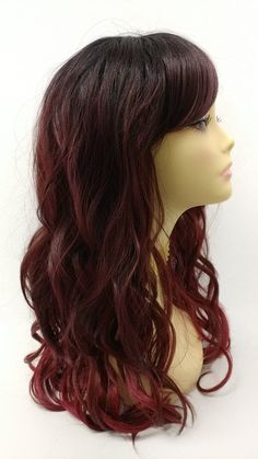 "Long wavy wig featuring beautiful beachy waves and bangs. Made with heat resistant fibers (up to 375F degrees). Inside cap has adjustable straps for a secure fit. Color: Burgundy with Dark Roots (TT/Burgundy) Style: Long and Wavy with Bangs Circumference: Default at 21\" with adjustable cap (max 22\"). Materials: Heat Resistant Fiber All sales are final. Please read all store policies before purchasing." Long Hair Burgundy, Wavy Burgundy Hair, Long Burgundy Hair With Bangs, Dark Brown To Maroon Ombre, Red Peekaboo Highlights, Dark Red Wavy Hair, Red Peekaboo, Red Curly Wig, Brown Hair Men