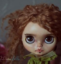 a close up of a doll with big eyes