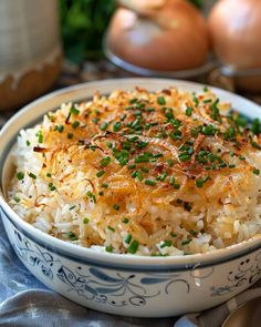 a bowl filled with rice and topped with green onions