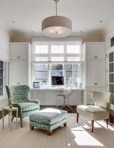 a living room filled with furniture and a computer on top of a window sill