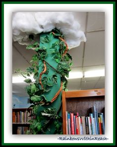 there is a green column with leaves on it and a cloud in the sky above