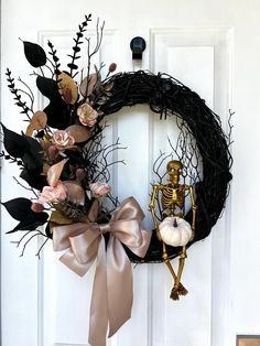 a halloween wreath with skeleton and flowers on the front door