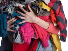 a woman's hand is on top of a pile of clothes