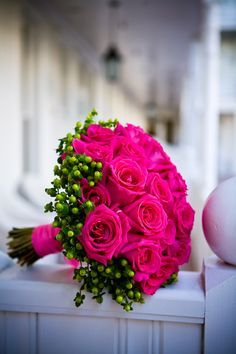 a bouquet of pink roses sitting on top of a table