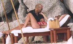 a man and woman are lounging on the beach