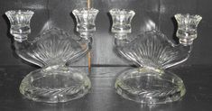 three glass candlesticks sitting next to each other