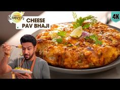 a man holding a plate with food on it next to a large pizza covered in toppings