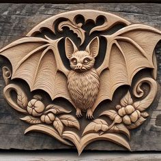 carved wood carving of a bat on the side of a building