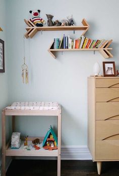 a baby's room with bookshelves and toys