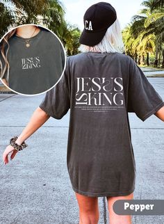 Introducing the Bible Verse T-shirt Jesus is King, a must-have for anyone seeking to spread the message of faith in style! This Comfort Colors Christian Shirt Crewneck makes the perfect Christian Gift for friends, family, or yourself. Runs true to size but size up if you would like a more oversized fit. Please check photo cards for detailed size guide. Comfort Colors®1717 is a made 100% with US cotton for long-lasting comfort. The soft-washed, garment-dyed fabric brings extra coziness to your wardrobe while the relaxed fit makes it an excellent daily choice.  Our designs are printed using the highest quality professional direct-to-garment (DTG) process, meaning fabric-grade ink is printed directly onto the garment and seamlessly blends with the fibres. This method enables us to achieve a v Christian Gift Shop, Christian Shirts Designs, Jesus Is King, Church Shirt, Bible Verse Shirt, King Tshirt, Jesus Shirt, Jesus Tshirts, Christian T Shirt