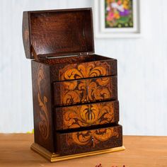 a wooden jewelry box sitting on top of a table