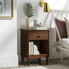 a bedroom with white brick walls and wood furniture, including a nightstand table that has books on it