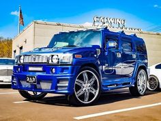 a blue hummer is parked in front of a building