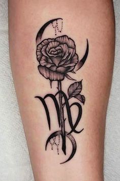 a rose tattoo with the letter m on it