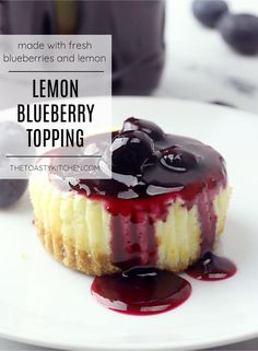 a lemon blueberry topping on top of a cheesecake with chocolate sauce in the middle