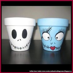 two cups with faces painted on them sitting next to each other