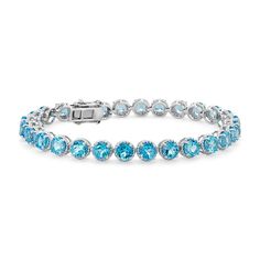 Delicately hued; this blue topaz bracelet is crafted in sterling silver and features twenty-eight lightly-colored; round Swiss blue topaz gemstones in a flexible single line design. Topaz Jewelry November, Topaz Bracelet, Blue Topaz Jewelry, Blue Topaz Bracelet, Gems Bracelet, Precious Gemstones Jewelry, Topaz Jewelry, Single Line, Sky Blue Topaz