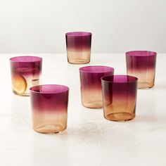 four glasses are sitting on a table