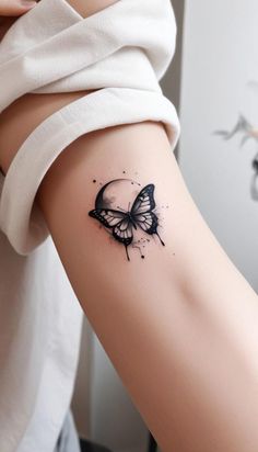 a woman's arm with a butterfly tattoo on the left side of her body