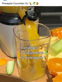 an orange juice is being poured into a blender with the ingredients in front of it