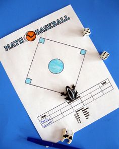 a paper game with two dices on top of it and a sheet of paper that says math baseball