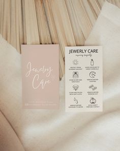 the jewelry care card is laying on top of some fabric