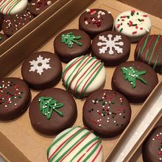 there are many decorated chocolates in the box and one is white, green and red