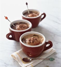 two cups of hot chocolate with spoons in them