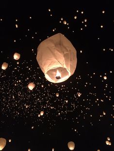 many lanterns floating in the air at night