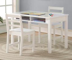 a white table with two chairs and a book shelf on top of it in front of a window