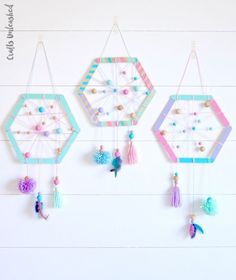 three colorful dream catchers hanging on the wall