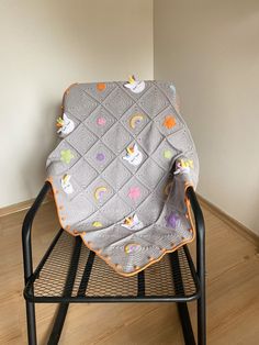 a baby blanket sitting on top of a chair