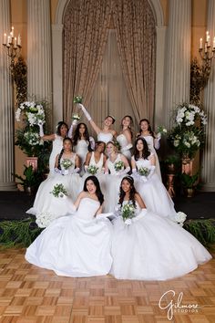 the bridesmaids pose for a photo in their wedding gowns