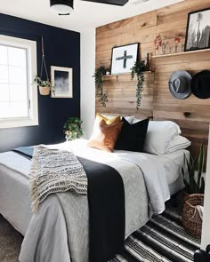 a bed room with a neatly made bed and pictures on the wall above it's headboard