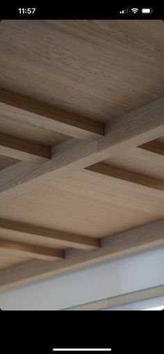 the ceiling is made of wood and has white trim on it's edges,