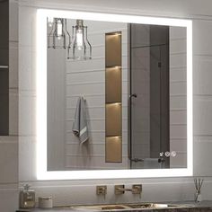 a bathroom with a sink, mirror and lights on the wall above it's counter