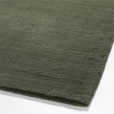 a large green rug on top of a white floor