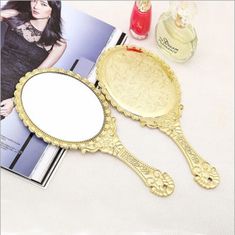 an ornate mirror sits on a table next to nail polish